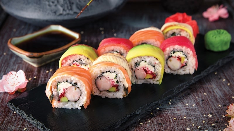 Rainbow Sushi Roll with salmon, eel, tuna, avocado, royal prawn, cream cheese Philadelphia, caviar tobica, chuka. Sushi menu. Japanese food.